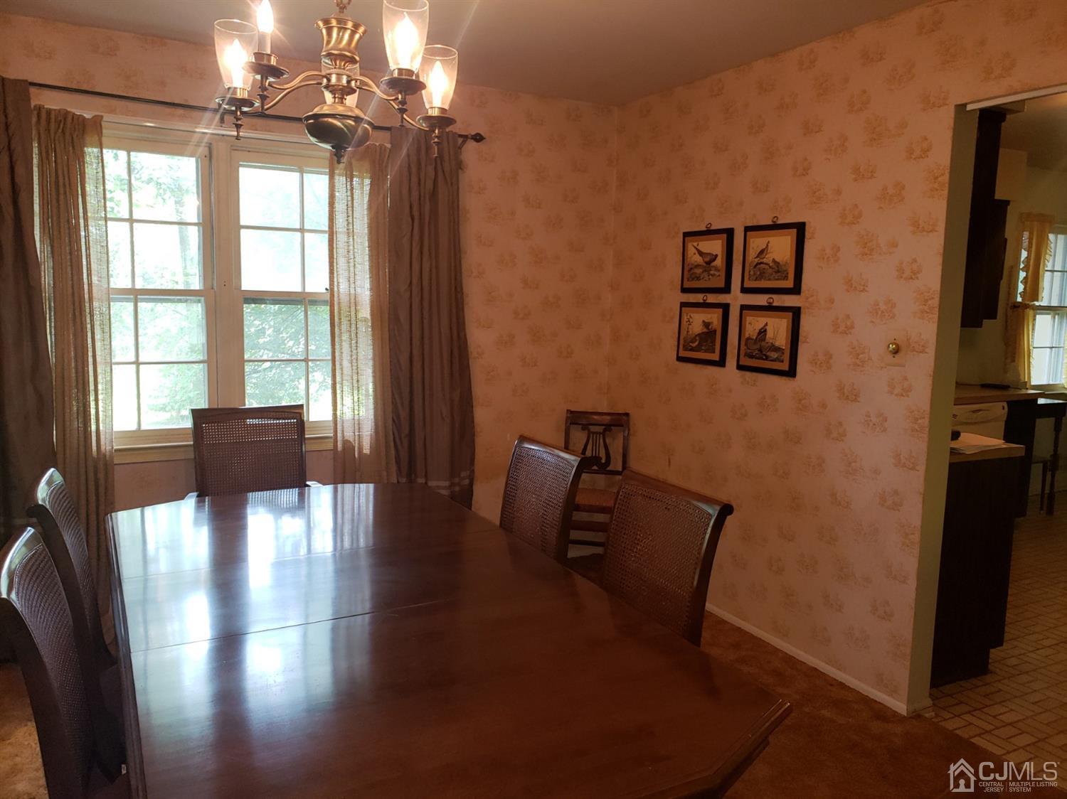 106 Fairfield Road Princeton, NJ 08540 - Photo 14 of 29 a view of a dining room with furniture a chandelier and wooden floor