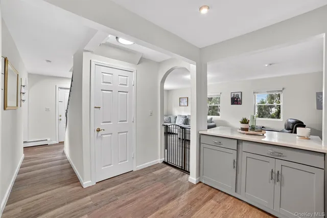 a room with white cabinets and sink