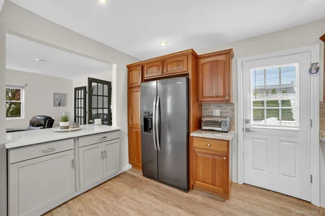 a kitchen with stainless steel appliances a refrigerator sink and cabinets