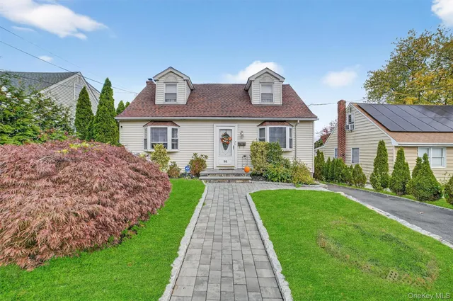 a front view of house with yard and green space