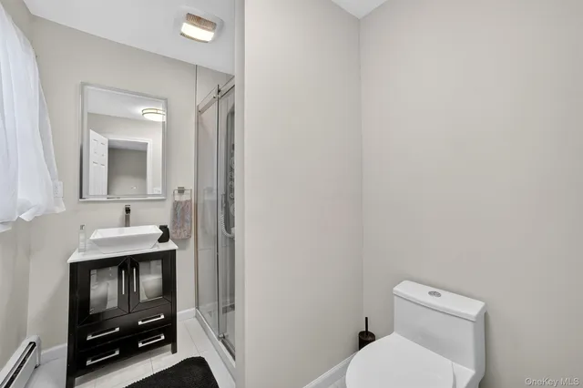 a bathroom with a toilet a sink and mirror