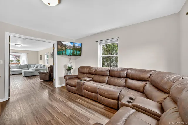 a living room with furniture a couch and a flat screen tv