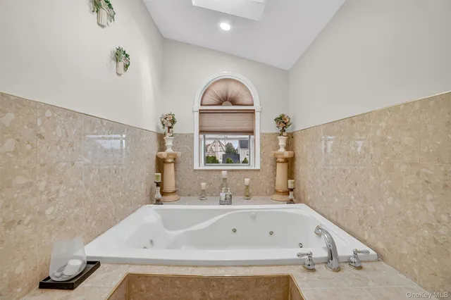 a bathroom with a bathtub and a window