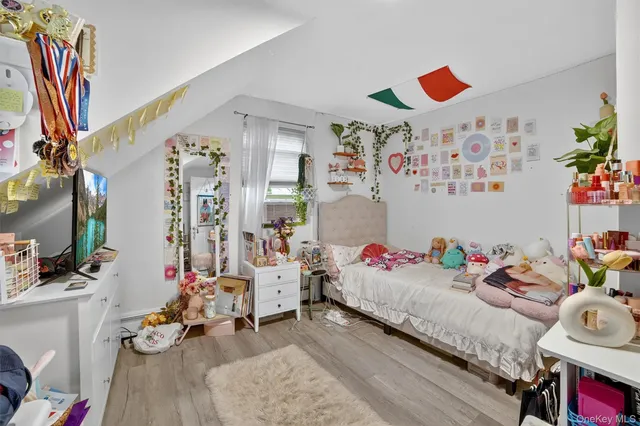 a bedroom with furniture and a book shelf