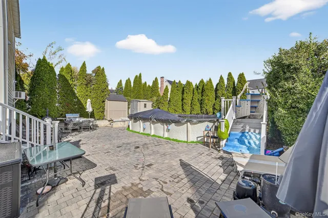 a view of a patio with table and chairs potted plants with wooden floor