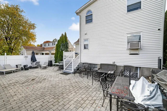 a backyard of a house with table and chairs