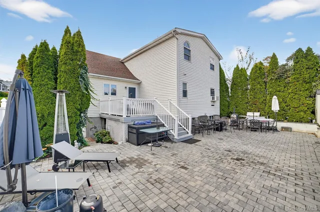 a view of backyard of house with seating space