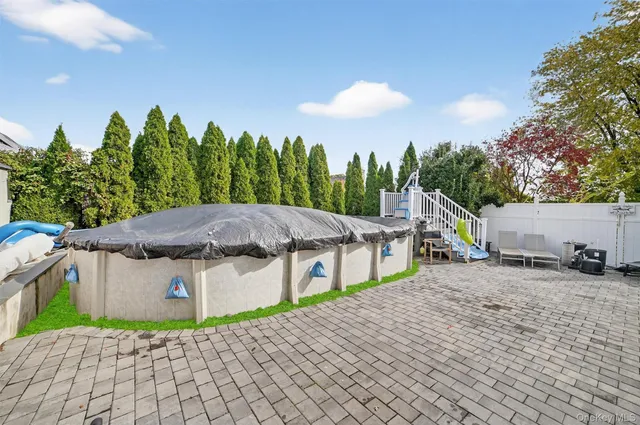 a view of a house with a patio and a yard