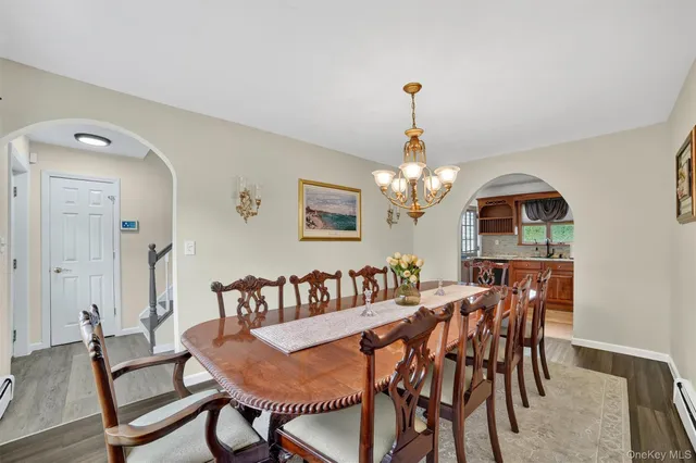 a view of a dining room with furniture and chandelier