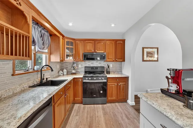 a kitchen with stainless steel appliances granite countertop a stove a sink and a granite counter tops