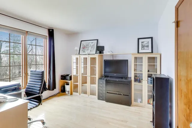 a room with a bed furniture and a flat tv screen
