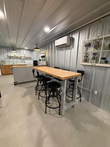 a dining room with a wooden table and chairs