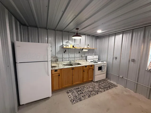 a kitchen with refrigerator and cabinets