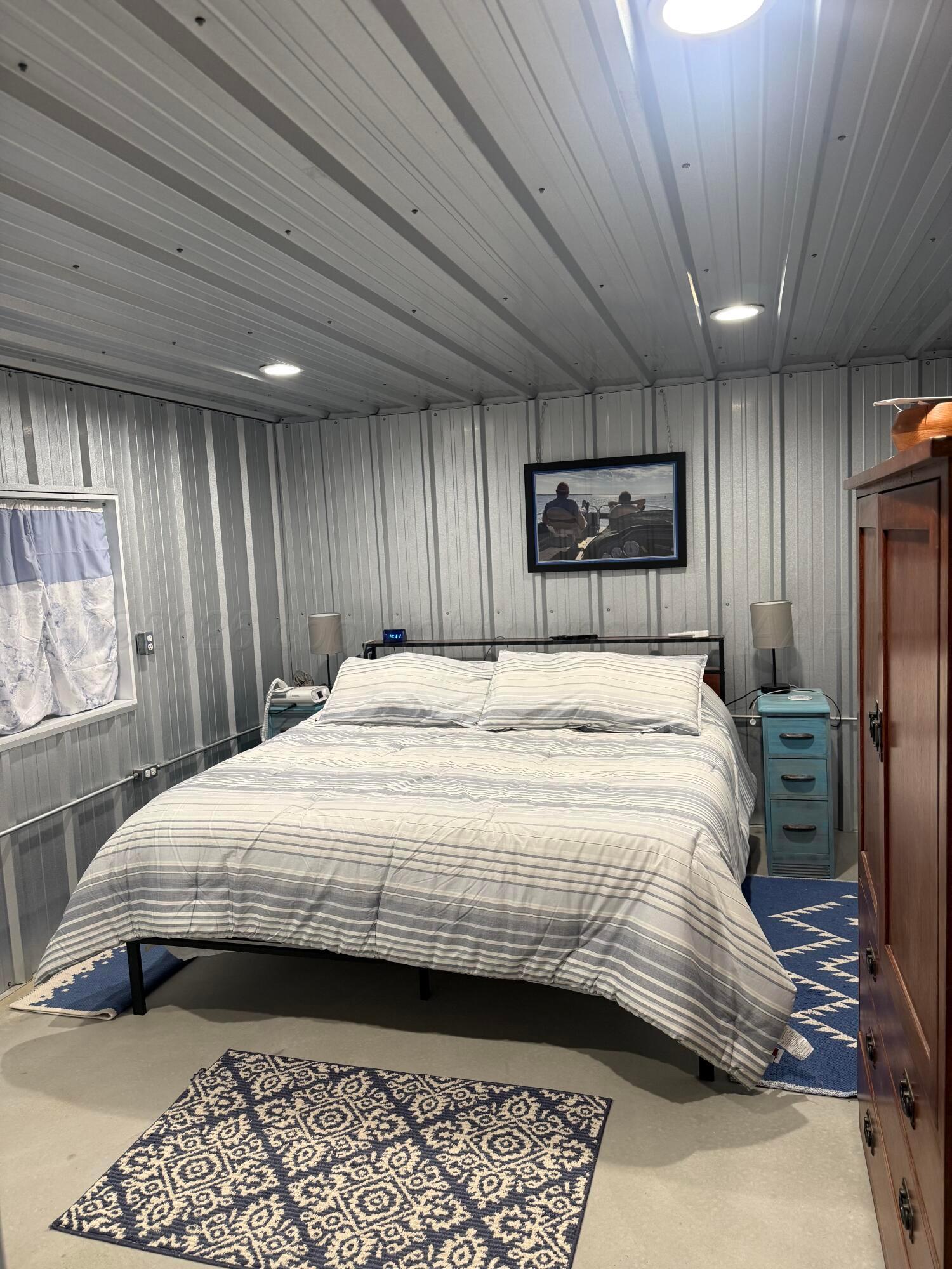 222 Bass Avenue Howardwick, TX 79226 - Photo 23 of 47 a bedroom with a bed and a large mirror