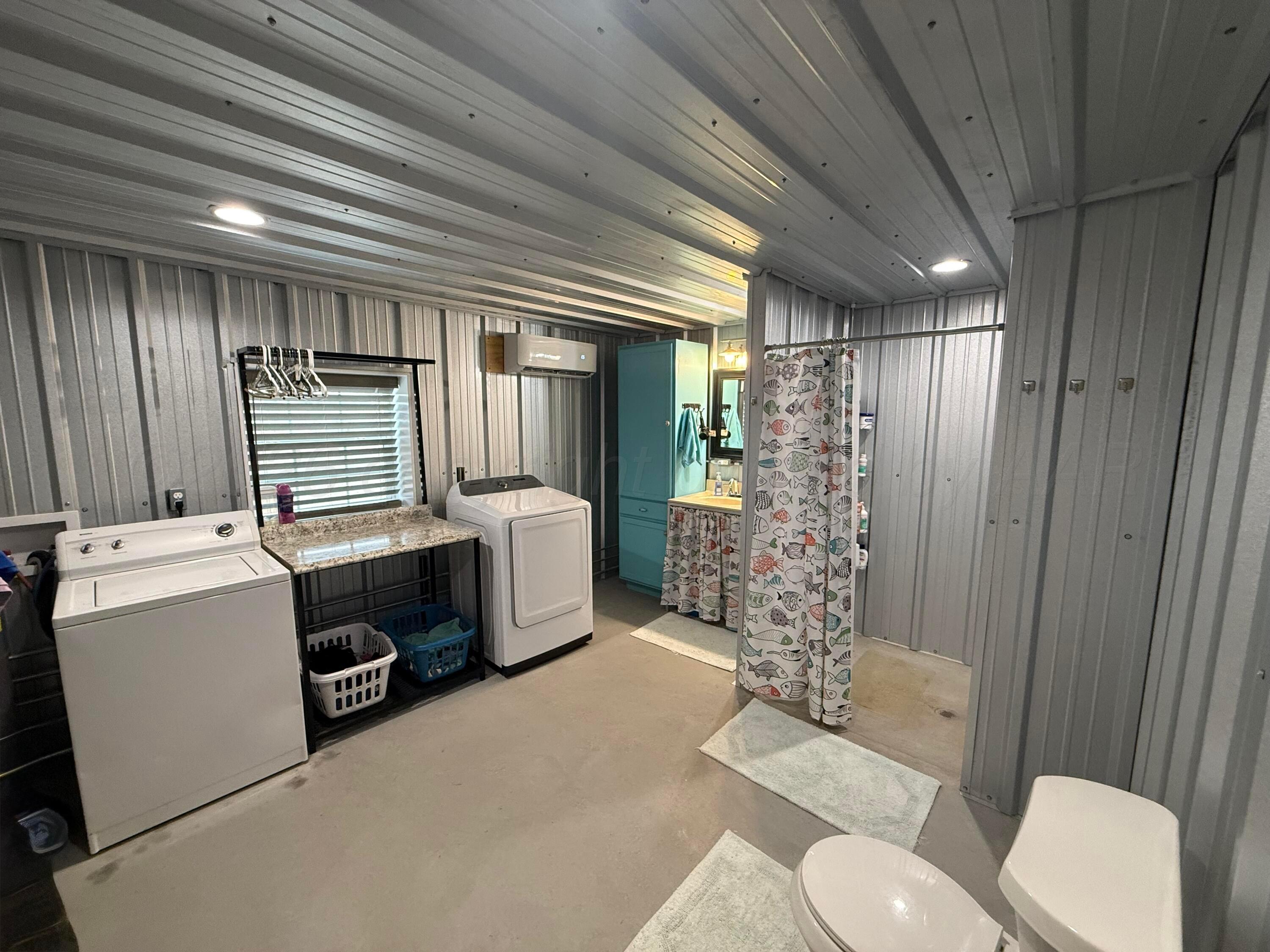 222 Bass Avenue Howardwick, TX 79226 - Photo 25 of 47 a bathroom with a sink a toilet a shower and a mirror