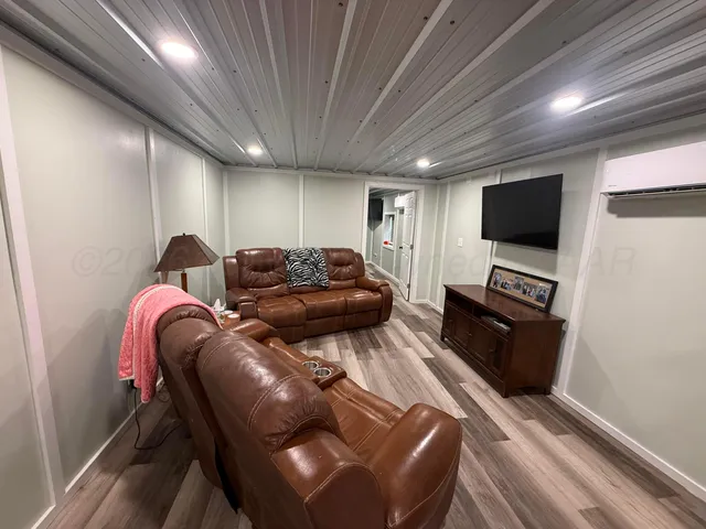 a bedroom with furniture and a wooden floor