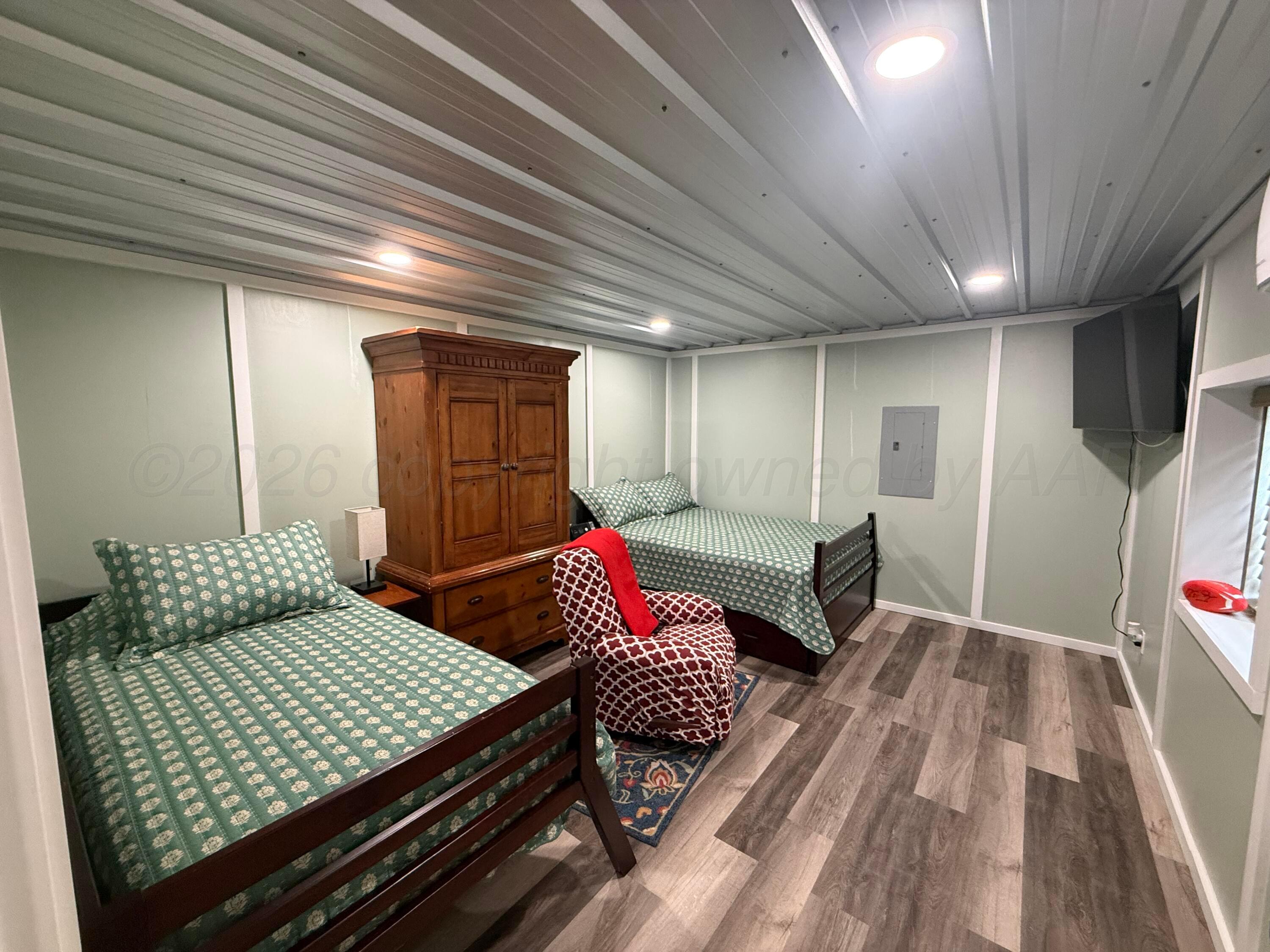 222 Bass Avenue Howardwick, TX 79226 - Photo 36 of 47 a bedroom with furniture and a wooden floor