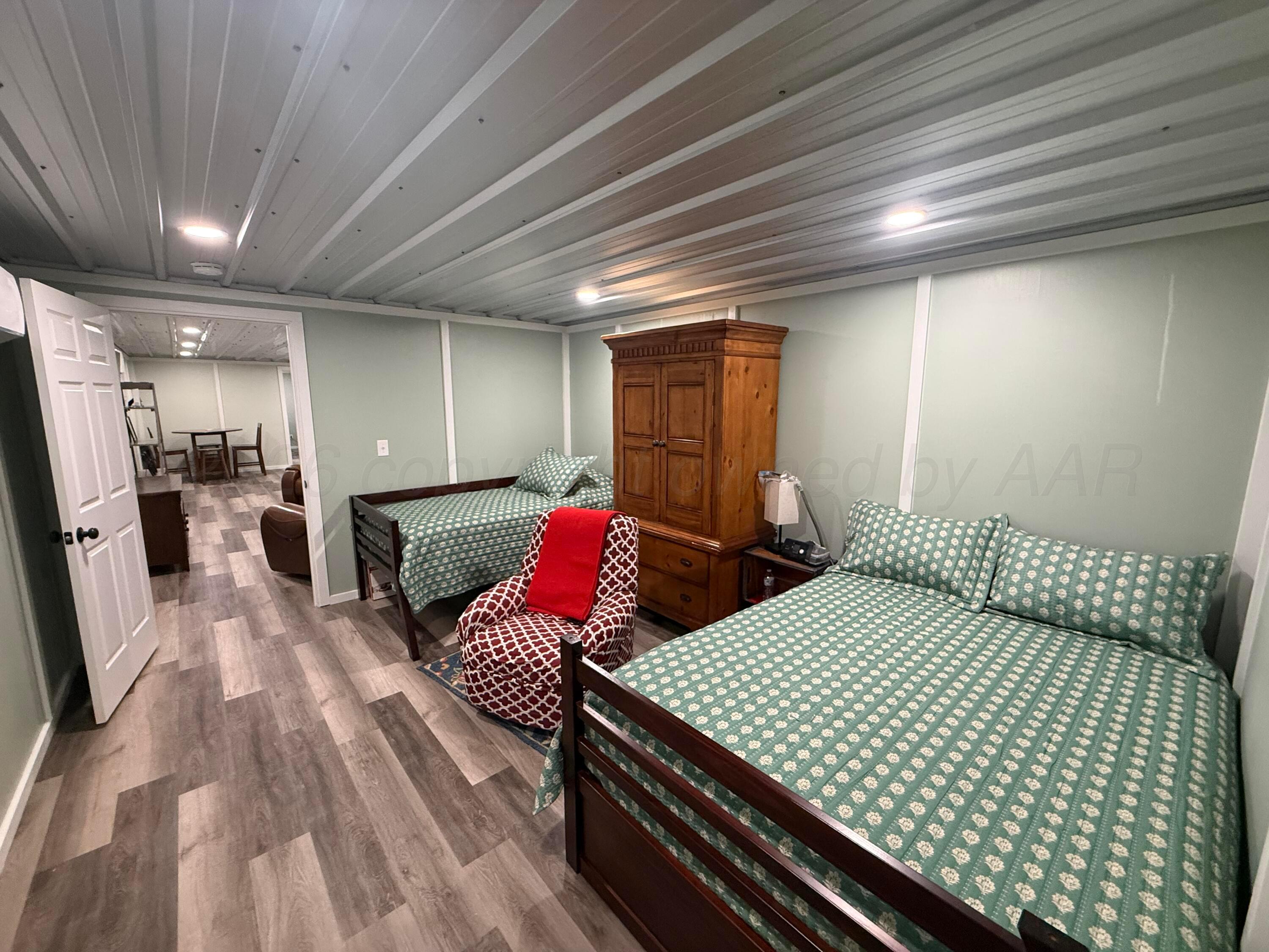 222 Bass Avenue Howardwick, TX 79226 - Photo 37 of 47 a bed room with two beds and a couch