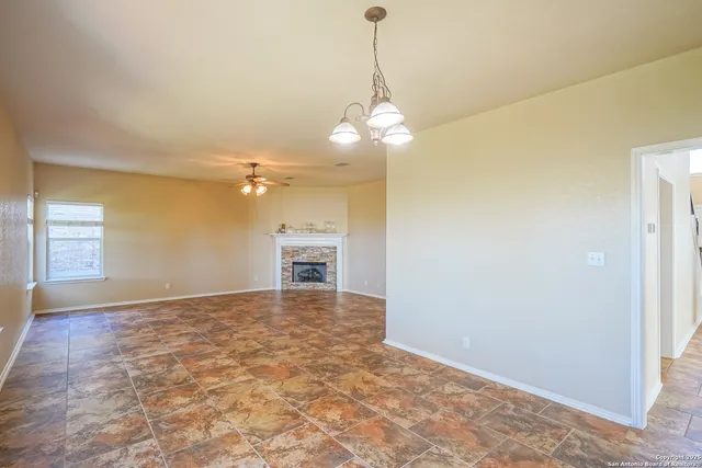 a view of a livingroom with a ceiling fan and window
