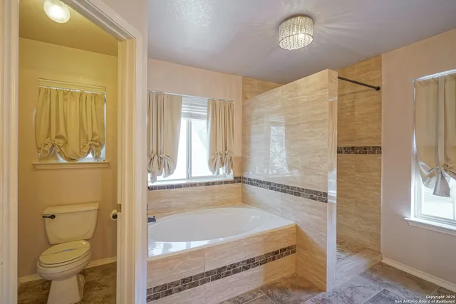 a bath room with a bath tub and a shower