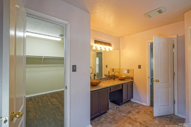 a view of a bathroom with a sink mirror and shower