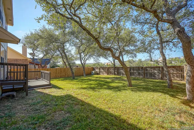 a house view with a sitting space and a trees