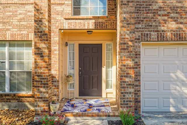 a front view of a building with a window and brick walls