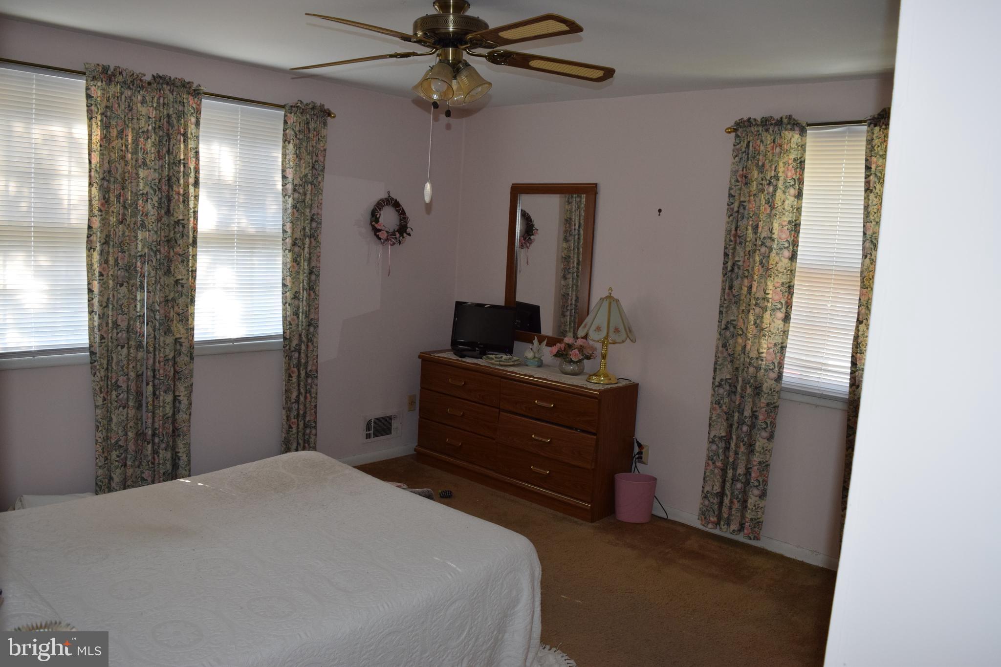 311 Radstock Road Catonsville, MD 21228 - Photo 12 of 21 a bedroom with a bed and a mirror