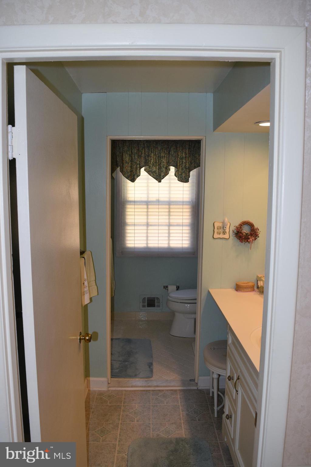 311 Radstock Road Catonsville, MD 21228 - Photo 14 of 21 a bathroom with a tub sink and mirror