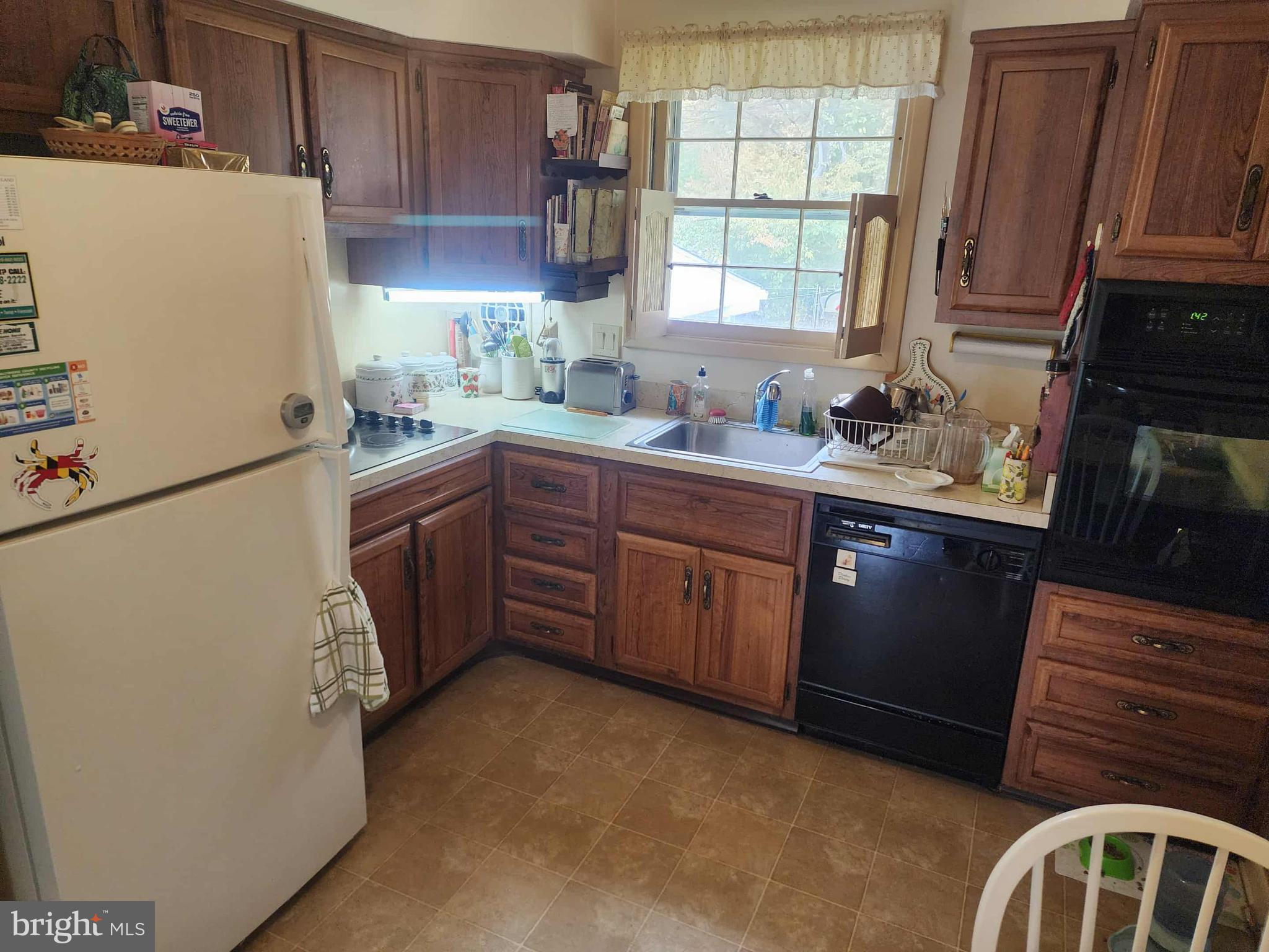 311 Radstock Road Catonsville, MD 21228 - Photo 6 of 21 a kitchen with a sink stove and refrigerator