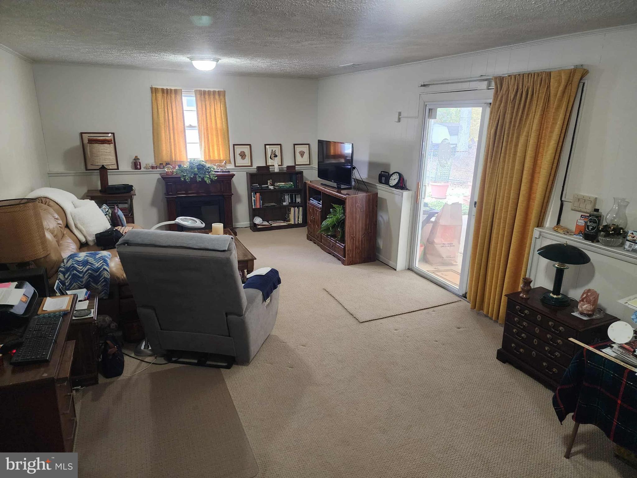 311 Radstock Road Catonsville, MD 21228 - Photo 9 of 21 a living room with furniture a flat screen tv and a window