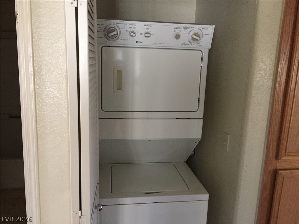 4730 East Craig Road, Unit 1091 Las Vegas, NV 89115 - Photo 13 of 14 A compact laundry space efficiently integrates a stacked washer and dryer unit.