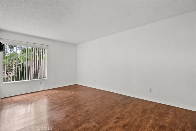 a bathroom with a granite countertop toilet sink and mirror