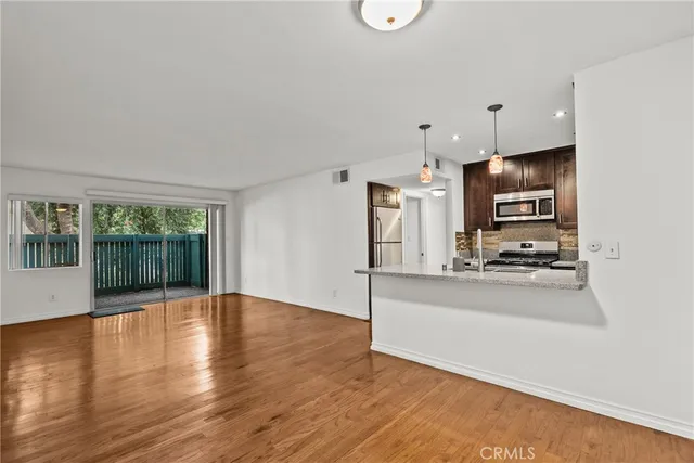 a kitchen with stainless steel appliances a refrigerator and a stove top oven