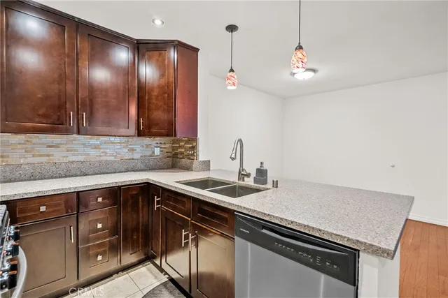 a view of a kitchen with a sink and a wooden floor