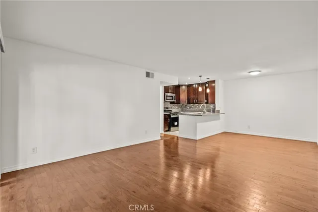 a view of a room with wooden floor and workspace