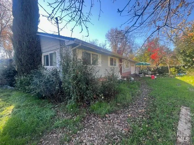 a view of a house with yard and tree s