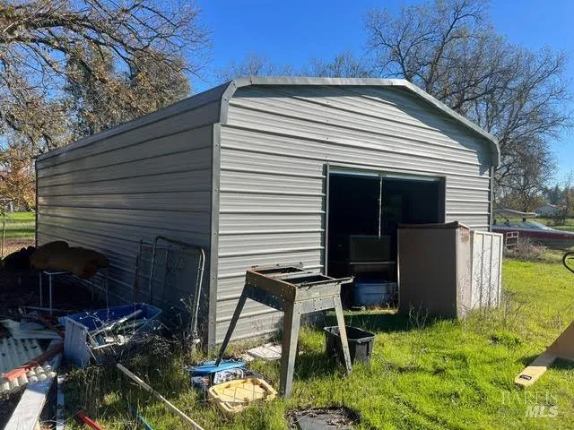 a view of backyard with a chair and potted plants