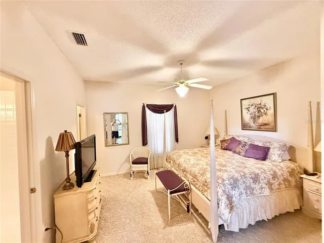 a bedroom with a bed and cabinets