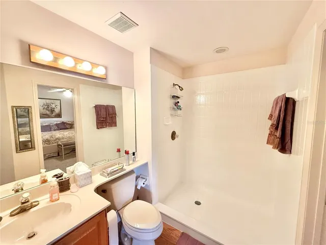 a bathroom with a sink a toilet and shower