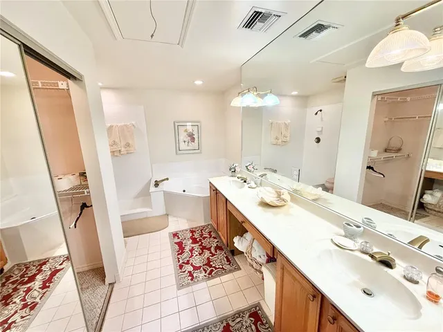 a spacious bathroom with a double vanity sink mirror and double