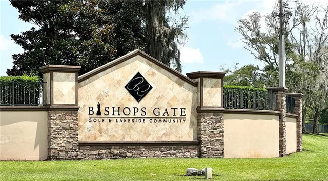 a view of a sign in front of a house with a yard