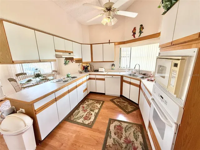 a kitchen with a stove a sink and a refrigerator