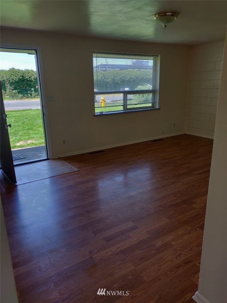 592 Southwest 18th Street Chehalis, WA 98532 - Photo 3 of 12 an empty room with wooden floor and windows