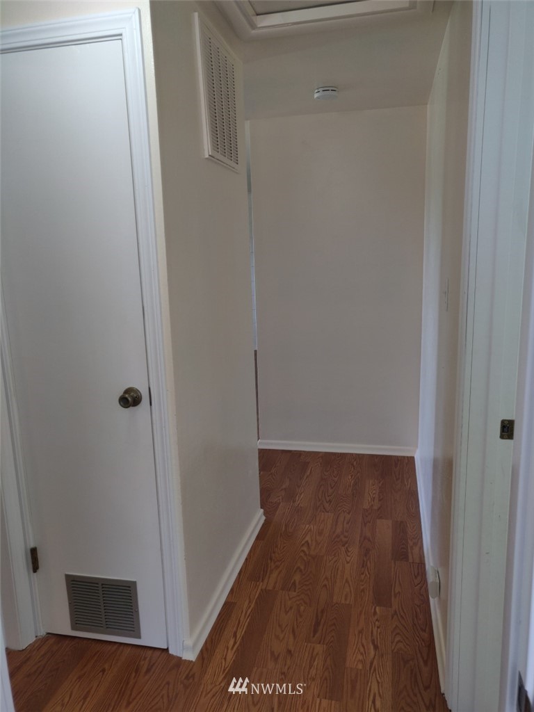 592 Southwest 18th Street Chehalis, WA 98532 - Photo 4 of 12 a view of a hallway with wooden floor
