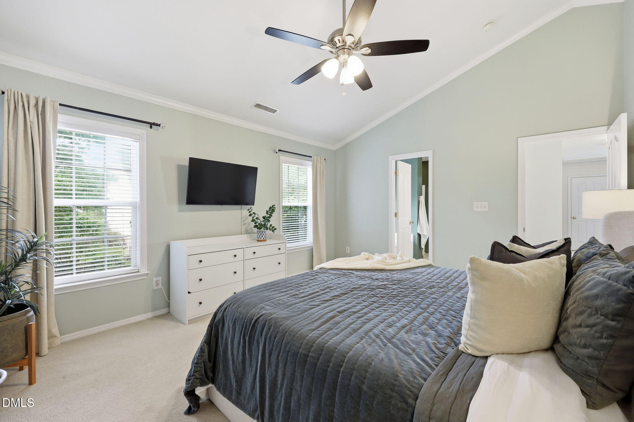 5629 Enoree Lane Raleigh, NC 27616 - Photo 20 of 38 a bedroom with a large bed and a flat screen tv