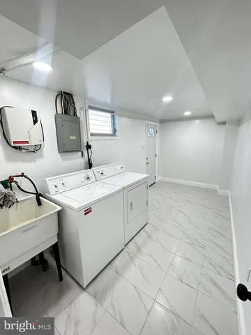 a utility room with a sink a washer and dryer