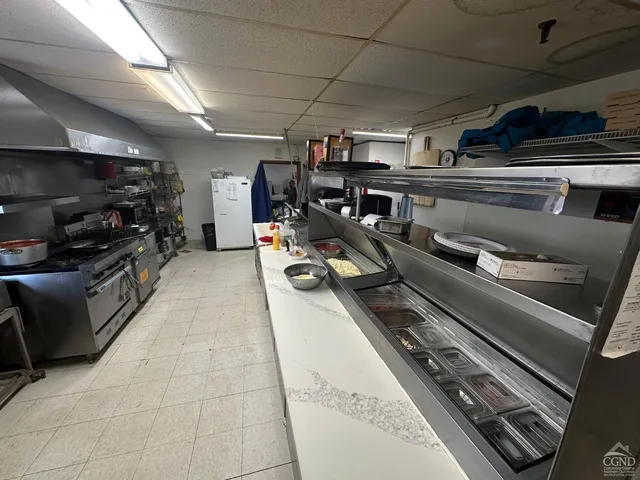 a stove top oven sitting inside of a kitchen