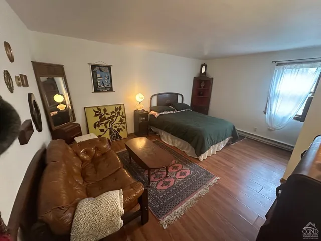 a living room with furniture a wooden floor and a fireplace