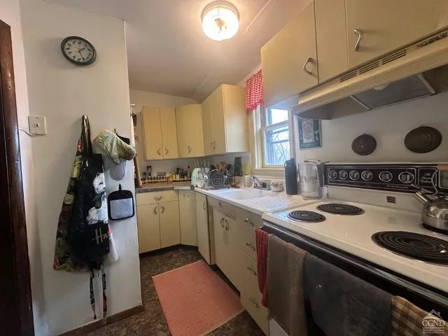 a living room with furniture and a mirror
